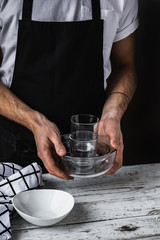 Waiter holding bunch of clean dishes. Restaurant stuff. Employee.