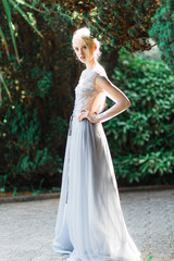 Fototapeta na wymiar Stunning bride portrait in beautiful wedding dress on natural background.