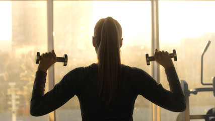 Woman of middle age working out in gym.