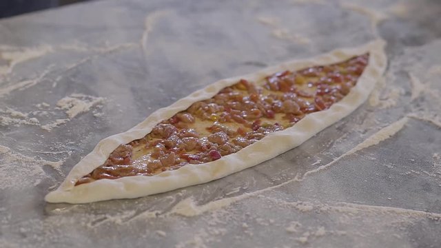 Close up dough with roasted meat with vegetables are ready for baking.