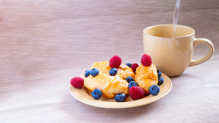 fresh juicy summer berries raspberry and blueberry with drops of honey in a natural beige cotton cloth. 