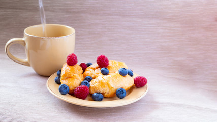 fresh juicy summer berries raspberry and blueberry with drops of honey in a natural beige cotton cloth. 