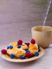 fresh juicy summer berries raspberry and blueberry with drops of honey in a natural beige cotton cloth. 