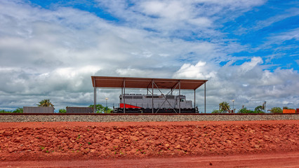 Freight diesel locomotive parked on train tracks at the end of t