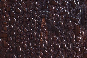 Water drops on dark wooden texture