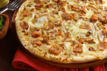 Fresh pizza on wooden table with ingredients