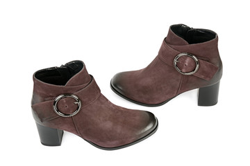 Elegant outfit. CloseUp of stylish suede ankle boots isolated on white background.