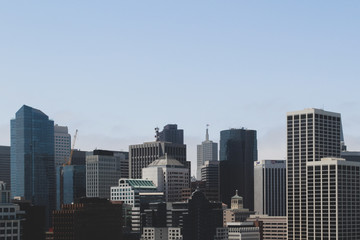 View of San Francisco city skyline with skyscrappers on blue sky background