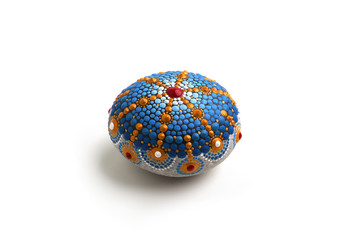 Beautiful mandala hand painted on a sea stone, isolated