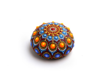 Beautiful mandala hand painted on a stone, isolated