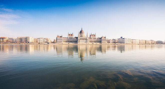 National Hungarian Parliament and Danube panorama with blue sky in Budapest, Hungary