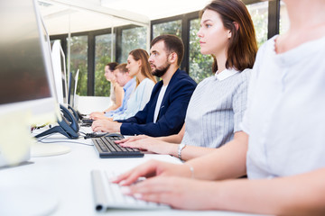 Obraz premium Coworkers sitting at workplace in modern office
