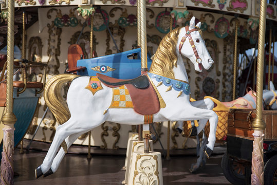 A white wooden horse on a merry-go-round