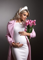 portrait of pregnant woman with pink flowers