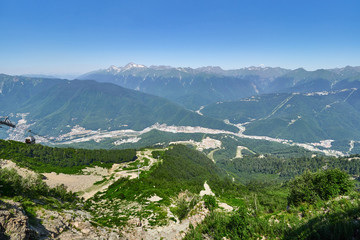 Fototapeta premium View over the Green Valley residential houses, surrounded by high mountains