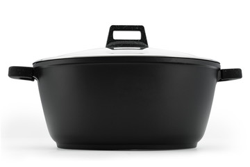 Kitchenware cauldron cauldron black metal glass lid isolate on a white background.
