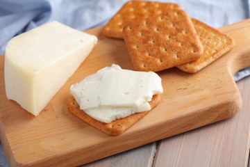 Crackers with Gouda Goat Milk Cheese  on wooden board