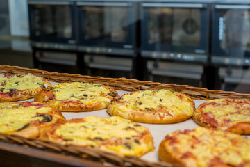 bakery products on display against the background of ovens in the bakery