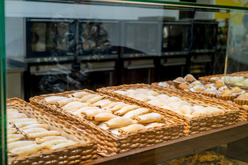bakery products on display against the background of ovens in the bakery