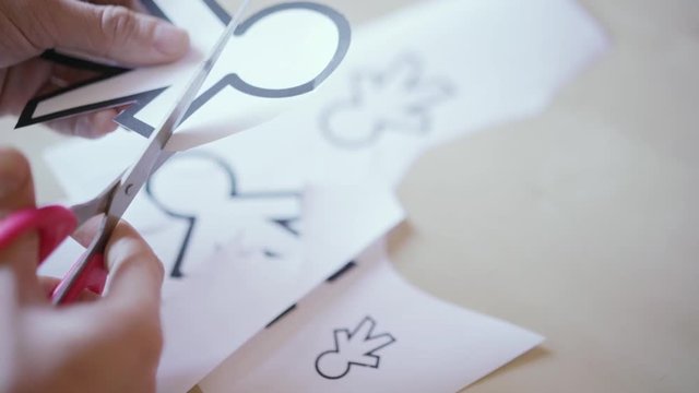 scissors cutting different paper silhouettes for April fools day
