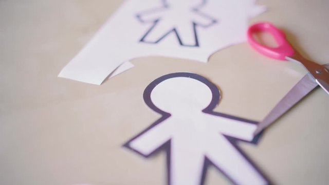 scissors cutting different paper silhouettes for April fools day