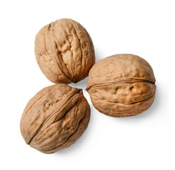 Three walnuts on a white isolated background. Close-up. View from above.