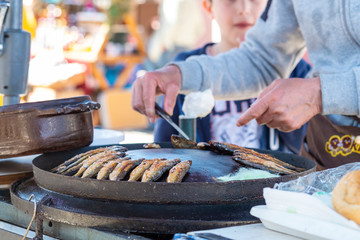 Festival of wine and fish in the Montenegrin town Virpazar. Montenegrins fry and sell fish on the street for festival guests