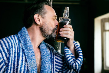 Close Up of a Brutal Beard With a Bottle of His Favorite Whiskey.