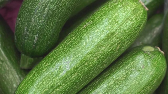 ripe green zucchini zucchini closeup on the market counter. Vegetable harvest