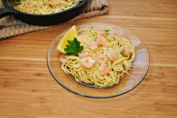 Shrimp Scampi on Pasta Served on a Glass Plate