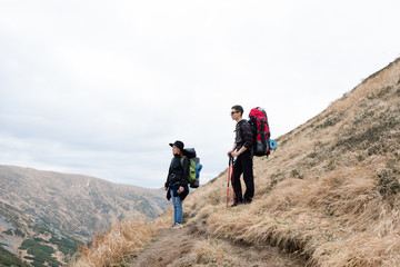 Fototapeta premium Friends travel through the mountains. Sports holidays.