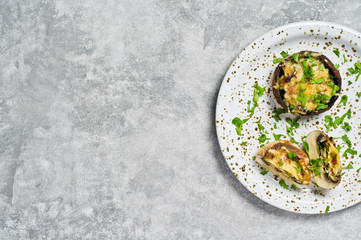 Baked stuffed mushrooms. Gray background, top view, space for text