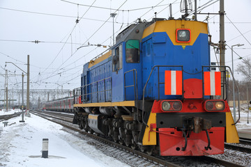 Fototapeta na wymiar Beautiful old fashioned locomotive at the railway station in winter