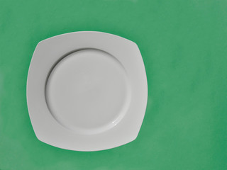 white plate on green background