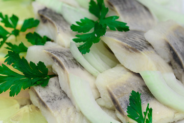 marimated herring with parsley, onion and lemon slices