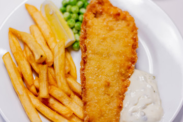 fried fish with french fries and vegetables