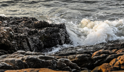 Sea surf splashing at rock