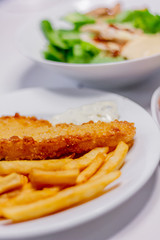 fried fish with french fries and vegetables
