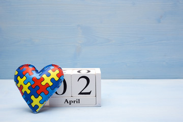 World Autism Awareness day, mental health care concept with puzzle or jigsaw pattern on heart with calendar