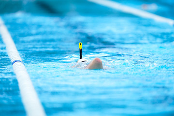 Details with a person snorkelling in an olympic swimming pool