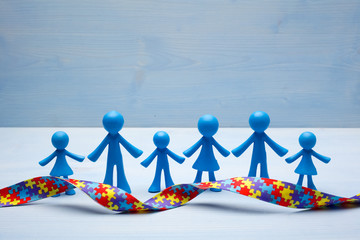 doll children background with symbolic autism puzzle ribbon