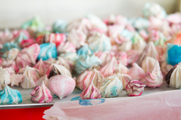 Pattern with meringues on a white background. Multicolored meringues on a white background.