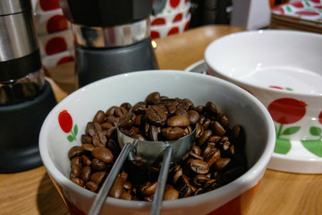 Porcelain mug with beautiful fresh coffee grains.