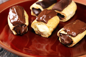 Traditional French dessert. Eclair with chocolate icing. Pastery concept with chocolate eclair