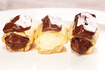 Traditional French dessert. Eclair with chocolate icing. Pastery concept with chocolate eclair