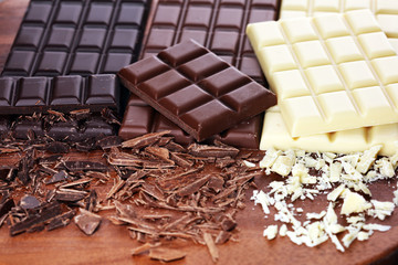 chocolate in diffrent color. milk, dark and white chocolate bars on table