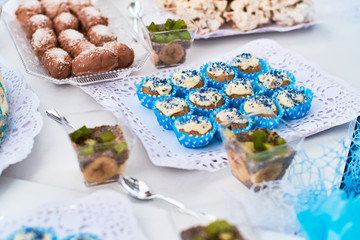 Beautiful variety of sweets on table with blue decorations