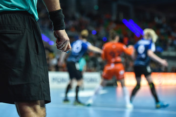 Handball referee hand with whistle