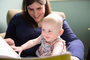 Mother reading book to baby