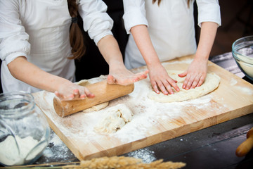 Obraz na płótnie Canvas two girls make flour dough.